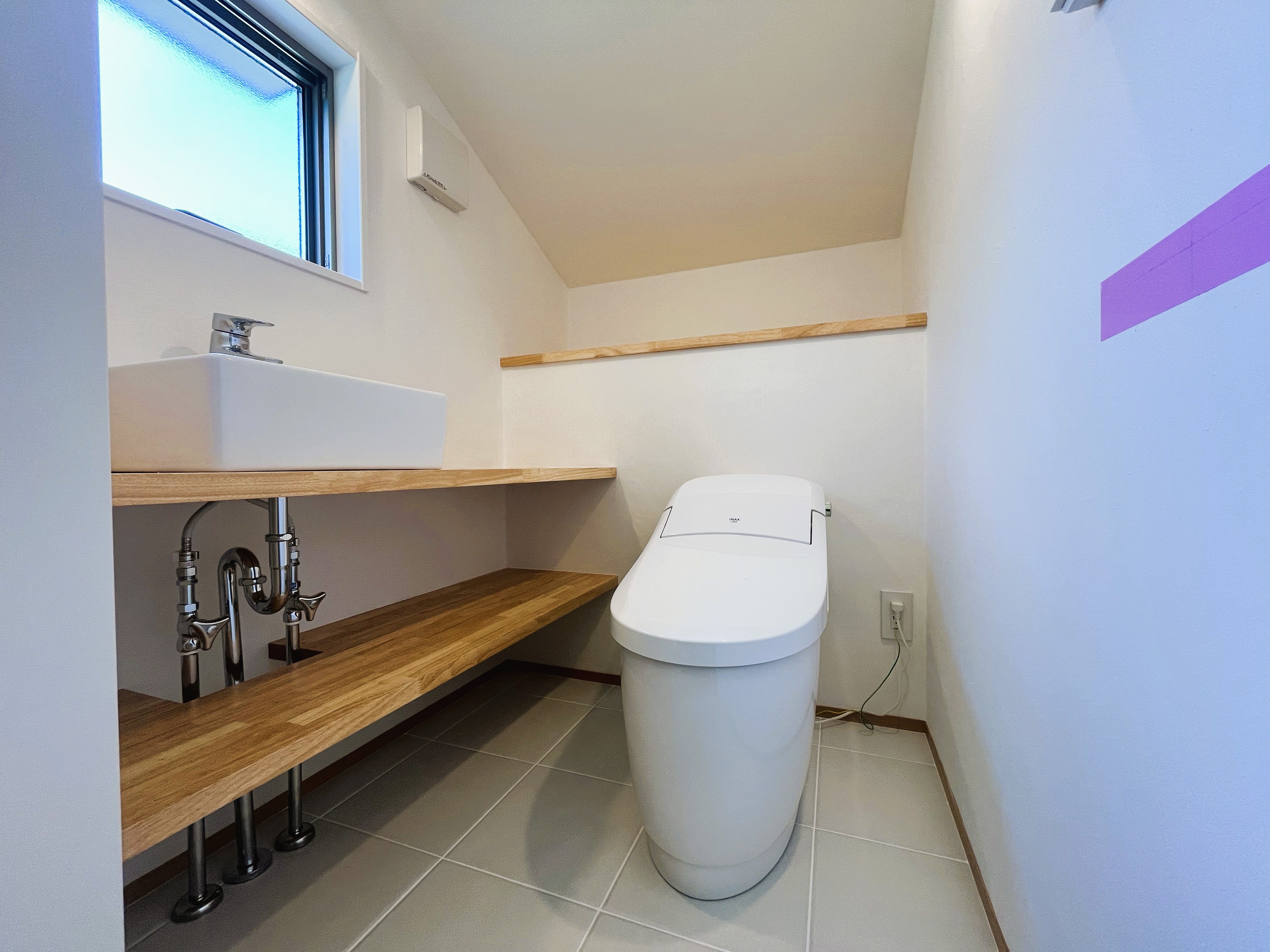 やわらかな色合いと木の質感が調和した、ぬくもり感じるトイレ空間